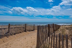 A beach with a wooden fence and a clear view of the ocean. - Luxury, newly renovated 2 bedroom condo with a beautiful oceanfront balcony! (Ocean City)