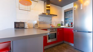 A modern kitchen with a microwave, coffee maker, oven, and a stainless steel refrigerator. - apartment 4E MAR2 2 bedrooms (Calpe/Calp)