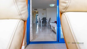 A view through a doorway into a room with a bed, a desk, and a chair. - 13D TB 2 bedrooms, 2nd line beach with sea views (Calpe/Calp)