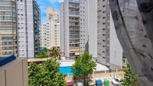 A high-rise residential building with multiple balconies, a swimming pool, and a view of other buildings. - 13D TB 2 bedrooms, 2nd line beach with sea views (Calpe/Calp)