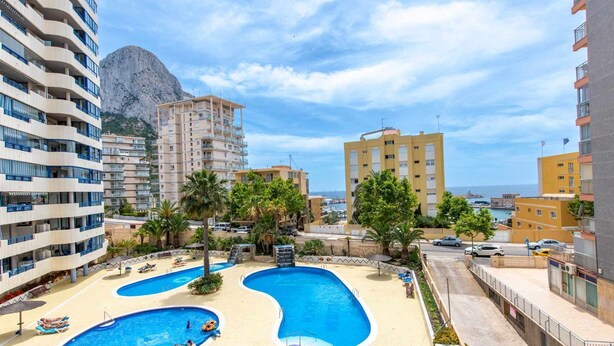 A resort with multiple swimming pools, a mountainous backdrop, and a coastal view. - 13D TB 2 bedrooms, 2nd line beach with sea views (Calpe/Calp)