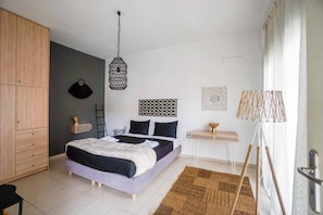 A bedroom with a bed, bedside table, lamp, wardrobe, and decorative wall art. - Yellow vibes for happy moments `Urban Yellow` (Rethymno)