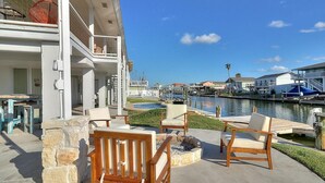 A waterfront patio with outdoor seating and a view of the marina.
