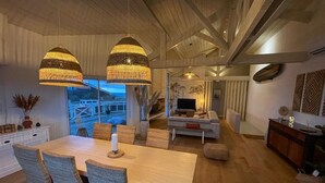 A modern living room with a sofa, TV, and decorative wall art. - "La Villa Tchanquée " Dominant view of the Ocean & Pines (Soorts-Hossegor)