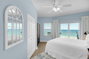 Enjoy ocean views from the large bed in this serene beachfront room.