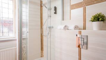 Shower, rainfall showerhead, hair dryer, towels