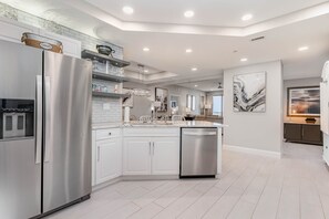 A modern kitchen with white cabinetry, stainless steel appliances, and a central island. - 908 Margate – Sophisticated Oceanview Retreat (Myrtle Beach)