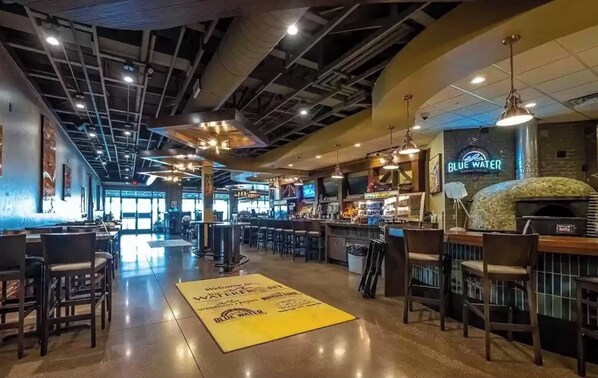 Enjoy a meal at our restaurant with a bar counter, seating area, and pizza oven.