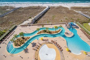 Ein Resort mit großzügigem Poolbereich, einer Promenade und Zugang zum Strand.
