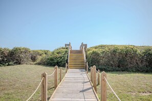 A wooden pathway leading to a staircase. - Anchors Away: Oceanfront Condo with Community Pool, Close to Oak Island Pier (Caswell Beach)