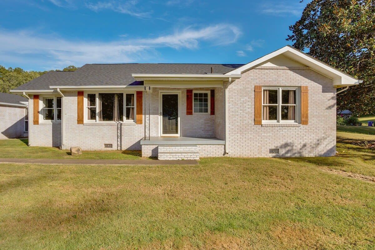 A single-story house with a front porch, a garage, and a small attached garage.