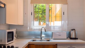 A modern kitchen with a built-in microwave, toaster, and coffee maker. - Apartment near the center with wonderful views of Begur. (Begur)