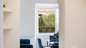 A modern room with a view of a bridge and trees through a window. - Amazing 2-bedrooms apartment in front of the Colosseo  (Roma)