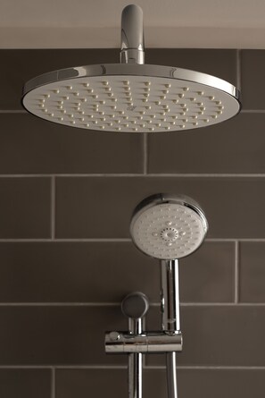 A modern showerhead with multiple spray settings, mounted on a chrome fixture.