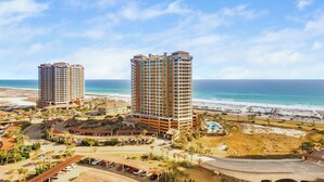 A resort with two high-rise buildings, a beach, and a parking area. - Great Gulf Views @ Portofino 4-1606! (Pensacola Beach)