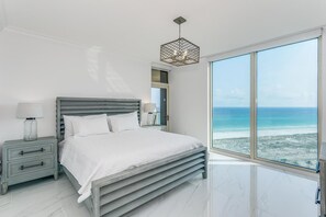 A bedroom with a large window offering a view of the ocean. - P5-1101 Newly Renovated - 3B Gulf Front @ Portofino (Pensacola Beach)