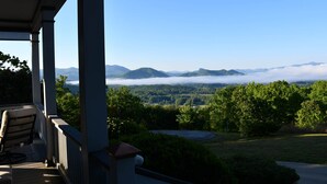A porch with a view of a mountainous landscape and a road. - Unwine'd With a View (Hayesville)