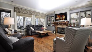 A living room with a fireplace, a television, and a sofa. - Unwine'd With a View (Hayesville)