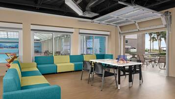 Enjoy meals and social gatherings in this stylish space with a dining table and comfortable seating areas.