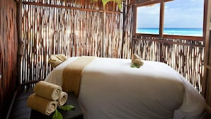 A room with a bed, a window with a view of the ocean, and a bamboo wall. - Studio - Westin Lagunamar Ocean Resort - Full Resort Access (Cancún)