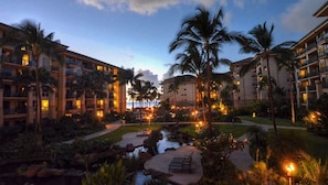 Stroll through the serene courtyard surrounded by palm trees and beautifully manicured lawns.