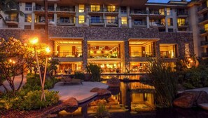 Experience the hotel's spacious lobby and enjoy a drink at the bar, surrounded by lush greenery and a serene water feature.