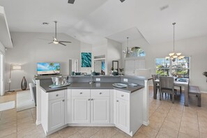 Enjoy cooking in this well-equipped kitchen with a large island, oven, and range hood.