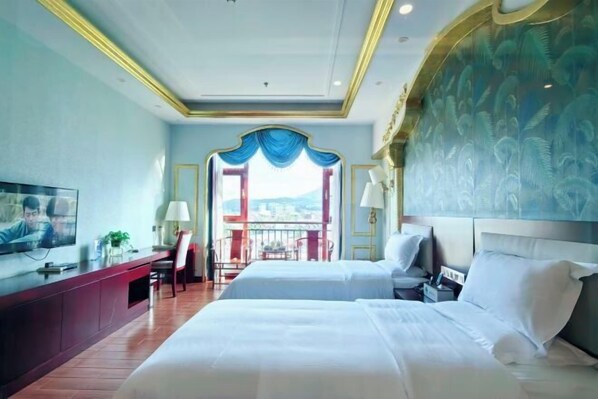 A hotel room with two beds, a TV, a desk, and a balcony with a view. - Lujiu Hotel (Xinping)