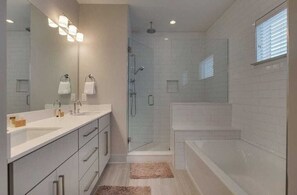 Bathtub, hair dryer, towels, shampoo