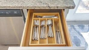 A drawer with utensils including forks, spoons, and a knife. - Stay near all Chas attractions, quiet comfort with fenced yard! (Goose Creek)
