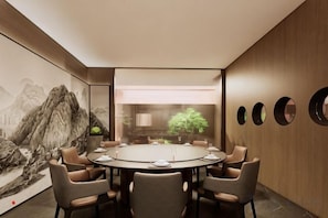 A conference room with a round table, six chairs, and a large painting on the wall. - Tang Dynasty Hotel (Ningjin)