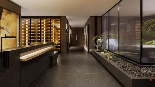 A modern hotel lobby with a reception desk, a seating area, and a decorative wall with a plant display. - Tang Dynasty Hotel (Ningjin)