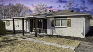 A single-story house with a covered porch, a brick exterior, and a small front yard with a stone pathway. - Newly remodel home 2BD/2BATH, 15min to dwtn Tulsa. (Owasso)