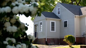A two-story house with a brick foundation and white siding. - Worsham Farmhouse (Farmville)