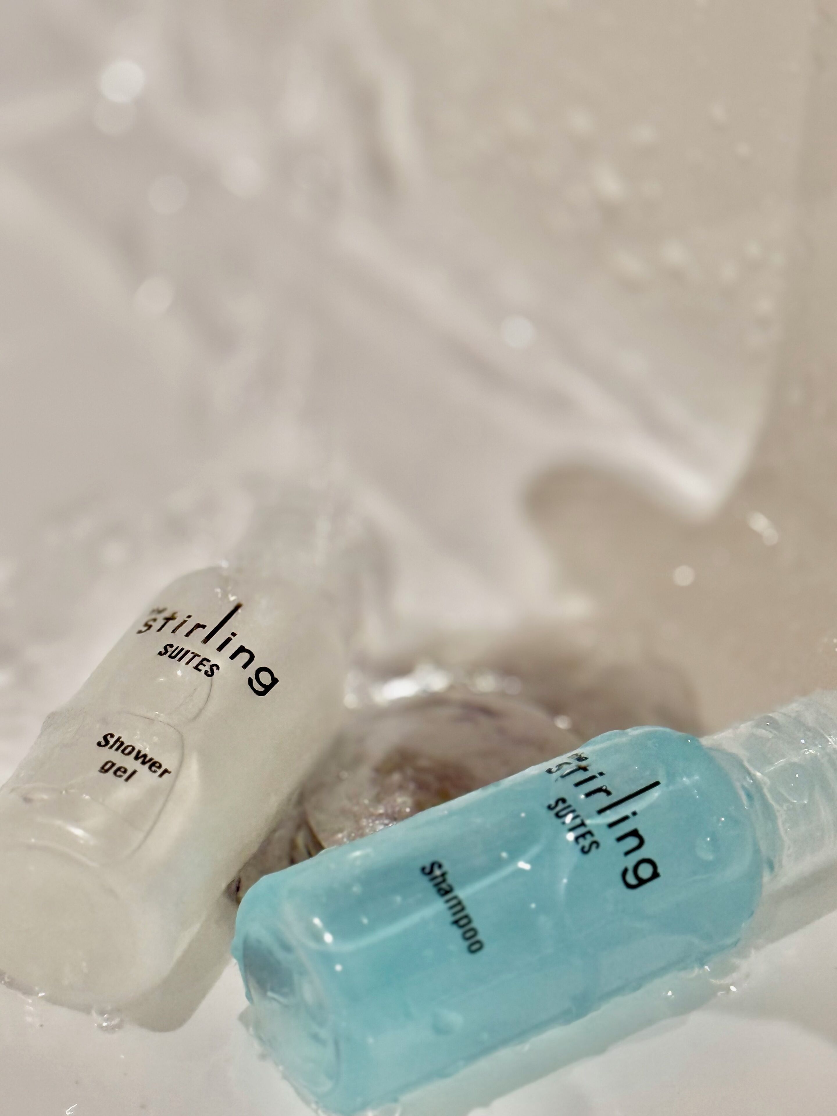 Two bottles of shower gel and shampoo from the brand Stirling Suites.