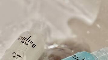 Two bottles of shower gel and shampoo from the brand Stirling Suites.