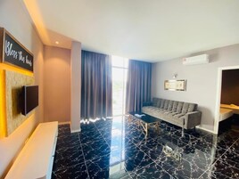 Apartment, 3 Bedrooms, Balcony | Living area | 32-inch Smart TV with cable channels, TV