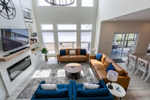 TV, fireplace, table football - LUXE Private Waterfront Retreat with Pool, Hot Tub and Game Room for Family Fun (Tracys Landing)