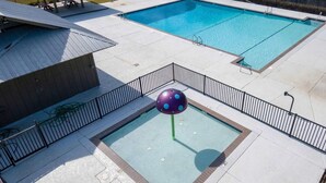 A swimming pool area with two pools, a covered seating area, and a small play structure. - Coastal Retreat • Daphne • Near Fairhope • Hot Tub • Massage Chair• Gulf Beaches (Daphne)