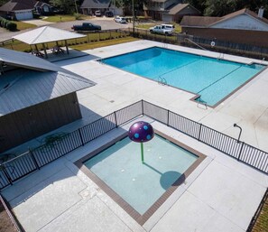 A swimming pool area with two pools, a covered seating area, and a small play structure. - Coastal Retreat • Daphne • Near Fairhope • Hot Tub • Massage Chair• Gulf Beaches (Daphne)