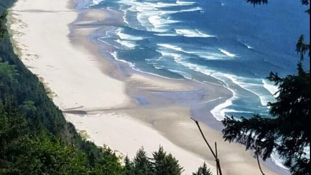 A coastal landscape with a sandy beach and ocean waves. - The Hideout (Crescent City)