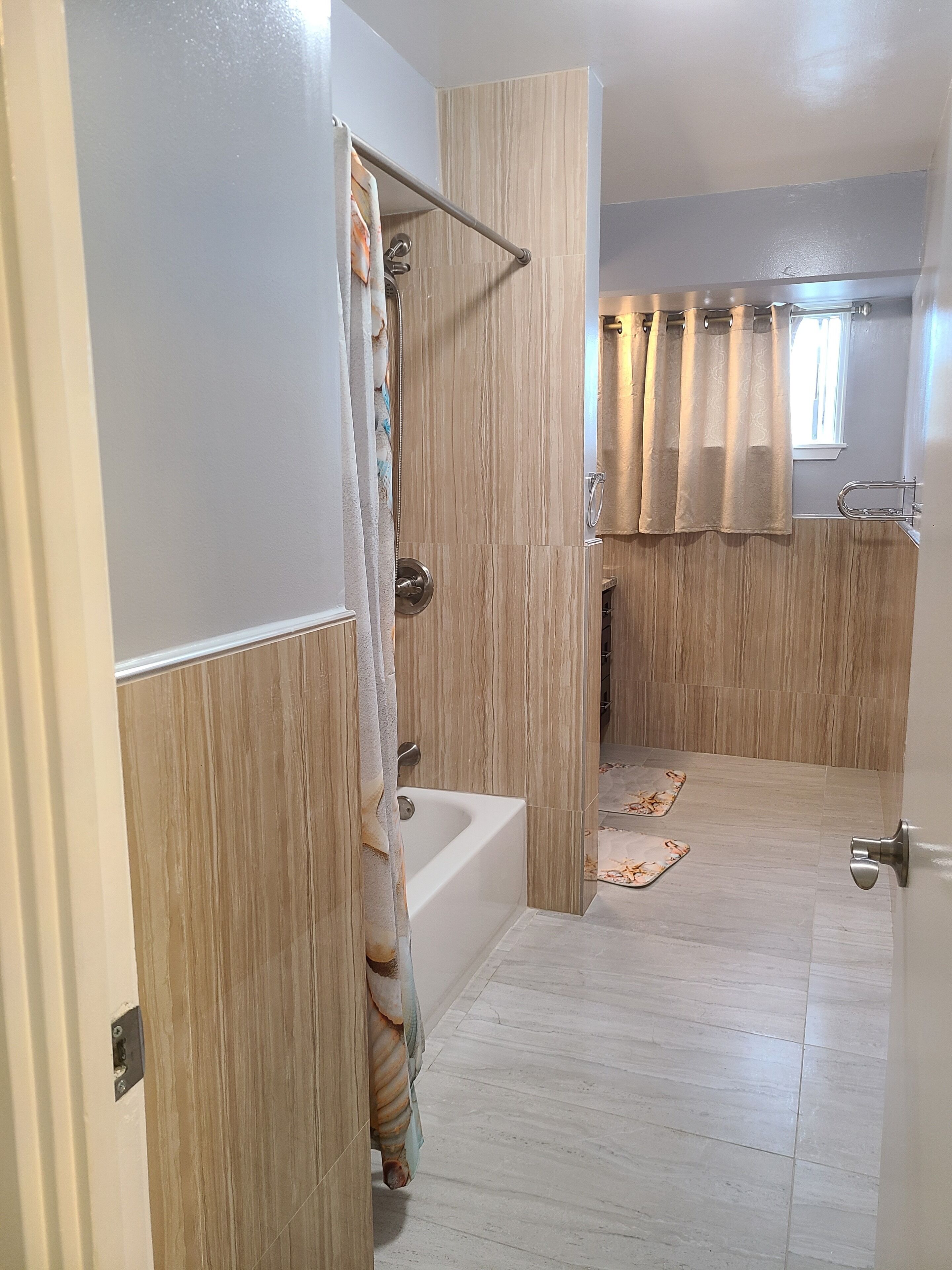 A bathroom with a bathtub, a shower area, and a toilet.