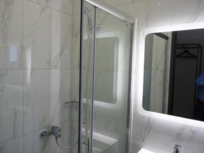 Shower, hair dryer, slippers, towels