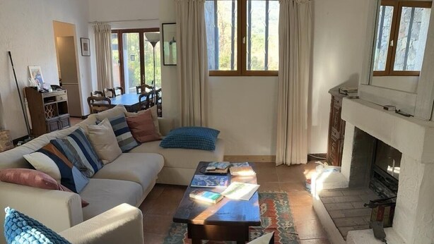 Un salon avec un canapé, une table basse et une cheminée.