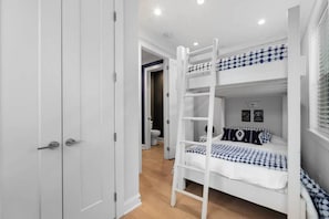 A bunk bed with a ladder, a white door, and a bathroom with a toilet. - BRAND NEW LISTING downtown Nashville - Nashtopia! (Nashville)