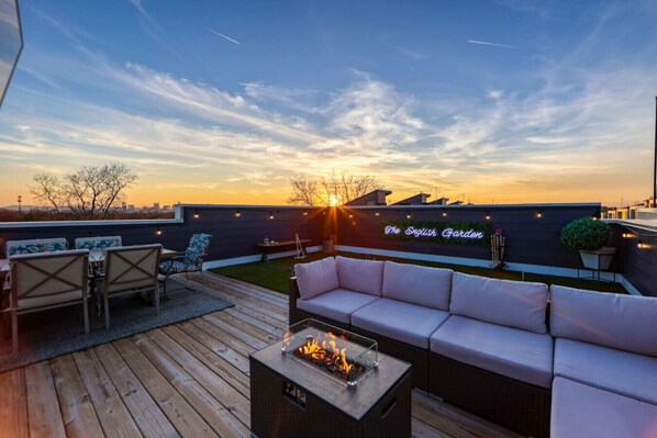 Relax on the rooftop terrace with a sofa, chairs, and table, and enjoy the view from the comfort of a fire pit.