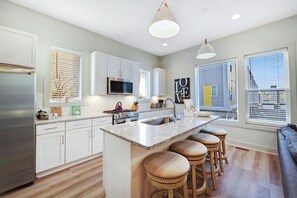 Enjoy cooking in this well-equipped kitchen with a central island and bar stools.