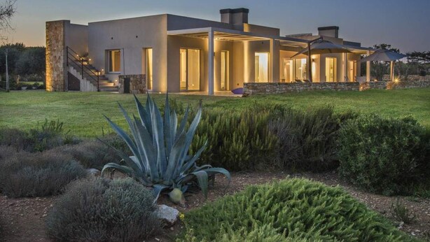 A modern house with a stone exterior, large windows, and a well-maintained garden. - Deluxe Suite, 1 Bedroom | Modern Minimalist Design Villa | Sea & Wild Beauty (Favignana)