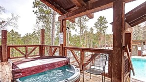 A wooden deck with a hot tub, a pool, and a covered area with a view of trees. - Great Escape - shared pool (Lead)