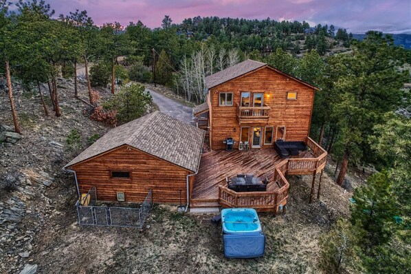 A wooden cabin with a deck, a hot tub, and a fenced area. - Newly Furnished Mountain Home - Private Hot Tub- Fooseball - Unbeatable Views (Bailey)